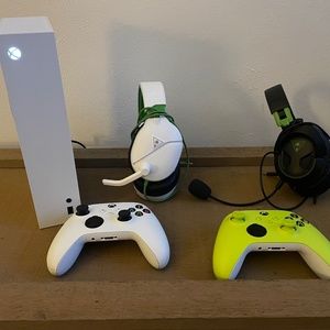 Xbox Series S with headsets and controllers